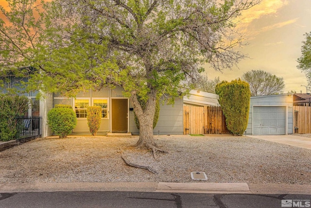 11420 Rocky Mountain St, Reno, NV 89506 - obstructed view of property featuring concrete driveway, fence, and a garage