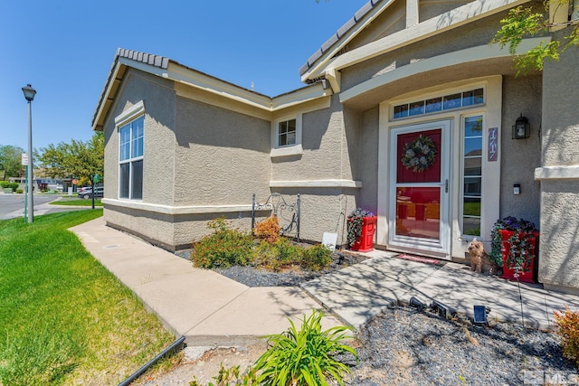 1717 Burwood Cir, Reno, NV 89521 - doorway to property featuring stucco siding and a yard