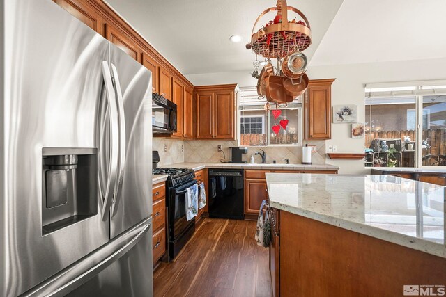1717 Burwood Cir, Reno, NV 89521 - kitchen featuring black appliances, healthy amount of natural light, dark wood-style floors, brown cabinets, and recessed lighting
