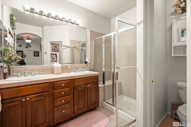 1717 Burwood Cir, Reno, NV 89521 - full bath featuring toilet, a shower stall, tile patterned flooring, double vanity, and ceiling fan