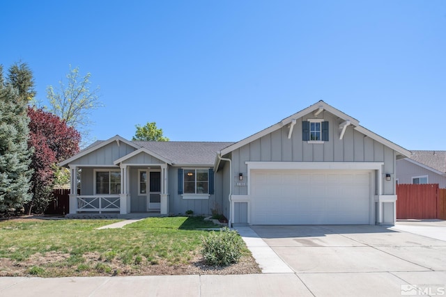2765 Erin Dr, Sparks, NV 89436 - ranch-style house with a garage, driveway, covered porch, board and batten siding, and roof with shingles