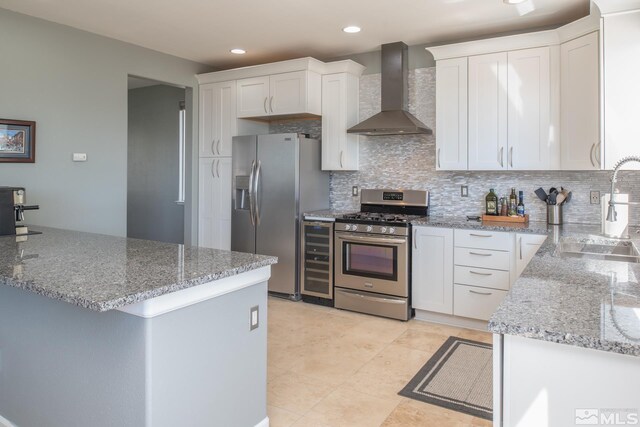 2765 Erin Dr, Sparks, NV 89436 - kitchen with stainless steel appliances, wall chimney range hood, a sink, decorative backsplash, and beverage cooler