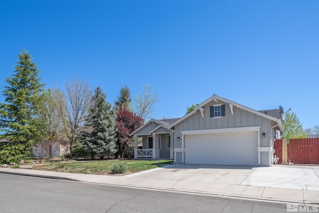 2765 Erin Dr, Sparks, NV 89436 - view of front of house featuring an attached garage, a porch, concrete driveway, and board and batten siding
