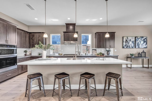 698 Sage Grouse Lp, Gardnerville, NV 89460 - kitchen with a sink, tasteful backsplash, dark brown cabinetry, and recessed lighting