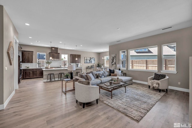 698 Sage Grouse Lp, Gardnerville, NV 89460 - living area with light wood-type flooring, baseboards, healthy amount of natural light, and recessed lighting