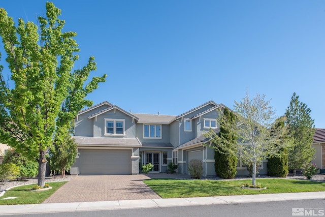 1304 Lambrusca Dr, Sparks, NV 89436 - view of front of property with decorative driveway, a garage, a front yard, a tile roof, and stucco siding
