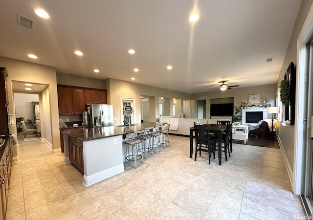 1304 Lambrusca Dr, Sparks, NV 89436 - kitchen with stainless steel refrigerator with ice dispenser, a kitchen bar, a ceiling fan, a spacious island, and open floor plan
