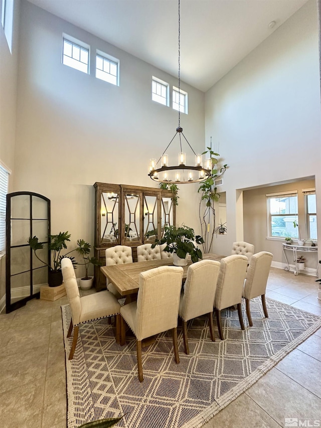 1304 Lambrusca Dr, Sparks, NV 89436 - dining room with a high ceiling, a chandelier, baseboards, and light tile patterned flooring