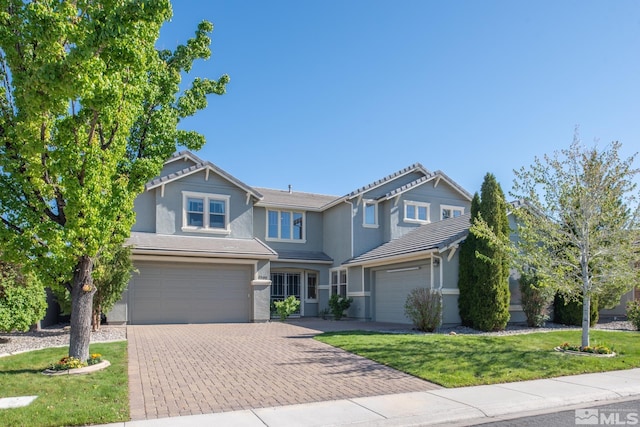 1304 Lambrusca Dr, Sparks, NV 89436 - view of front of house with decorative driveway, stucco siding, an attached garage, a front lawn, and a tile roof