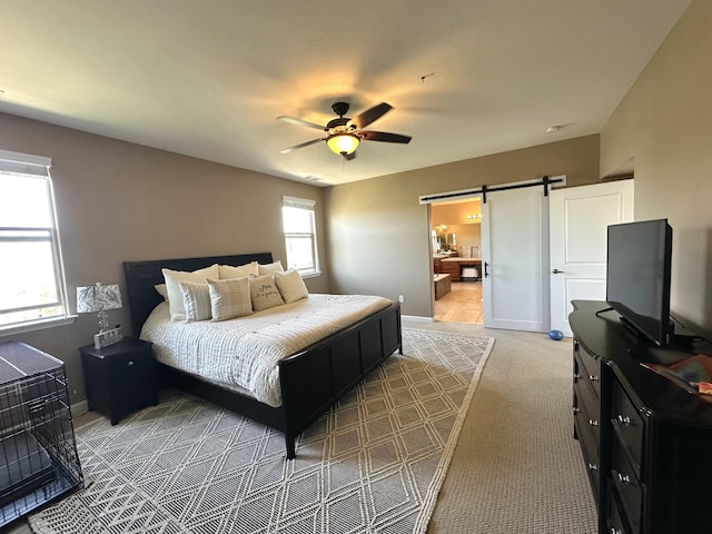 1304 Lambrusca Dr, Sparks, NV 89436 - bedroom with a barn door, baseboards, a ceiling fan, light colored carpet, and ensuite bathroom