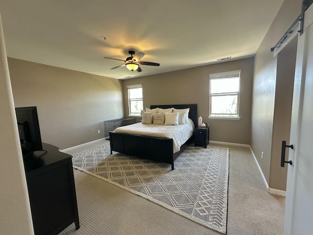 1304 Lambrusca Dr, Sparks, NV 89436 - carpeted bedroom featuring a barn door, ceiling fan, and baseboards