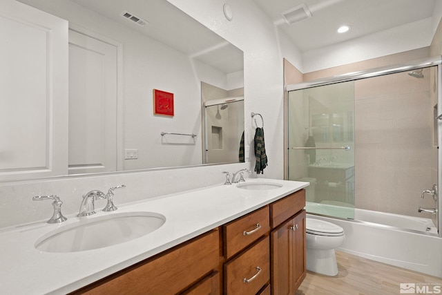 606 Braided Rope Dr, Reno, NV 89511 - bathroom featuring double vanity, enclosed tub / shower combo, and wood finished floors