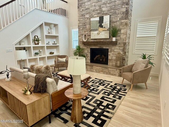 606 Braided Rope Dr, Reno, NV 89511 - living area featuring wood finished floors, a fireplace, a towering ceiling, and built in features