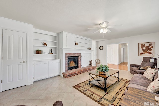 1871 Walnut Ct, Carson City, NV 89703 - living area featuring a ceiling fan, light tile patterned floors, a fireplace, and built in shelves