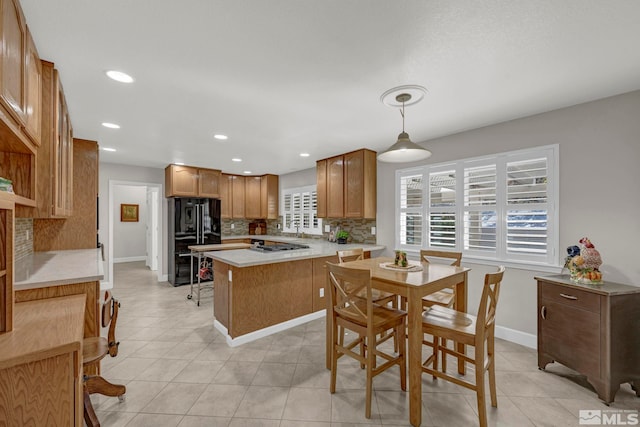 1871 Walnut Ct, Carson City, NV 89703 - kitchen with freestanding refrigerator, tasteful backsplash, light countertops, baseboards, and recessed lighting