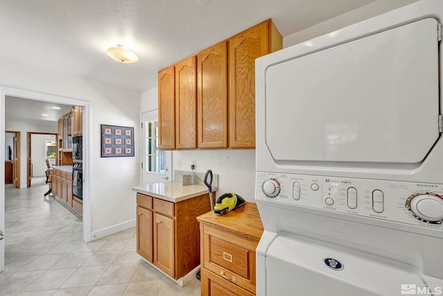 1871 Walnut Ct, Carson City, NV 89703 - washroom featuring stacked washer and clothes dryer, light tile patterned floors, and baseboards