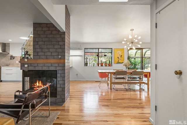 3255 Corey Dr, Reno, NV 89509 - dining space featuring light wood-style floors, a brick fireplace, baseboards, and a chandelier