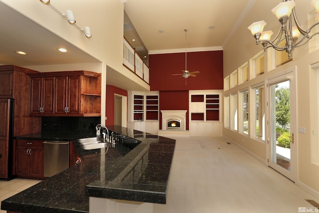 2459 Genoa Highlands, Genoa, NV 89411 - kitchen featuring stainless steel dishwasher, a sink, a ceiling fan, a towering ceiling, and crown molding