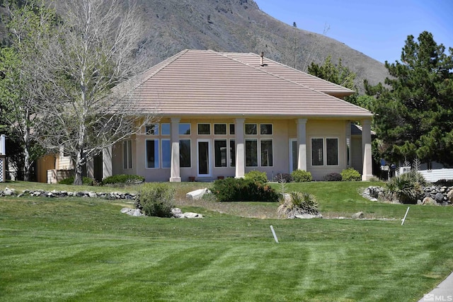 2459 Genoa Highlands, Genoa, NV 89411 - rear view of property with a tiled roof, a lawn, a mountain view, and stucco siding