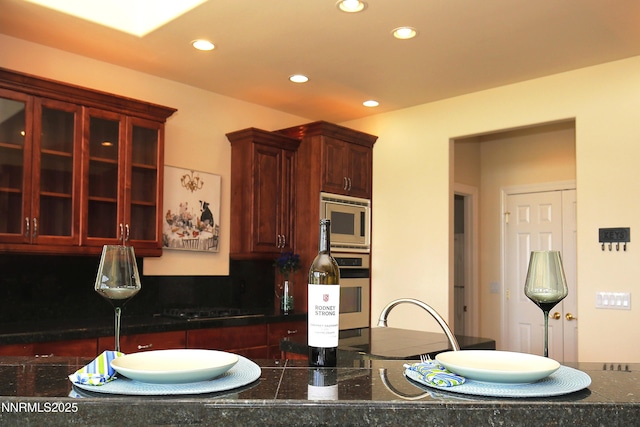 2459 Genoa Highlands, Genoa, NV 89411 - kitchen featuring appliances with stainless steel finishes, recessed lighting, dark countertops, reddish brown cabinets, and decorative backsplash