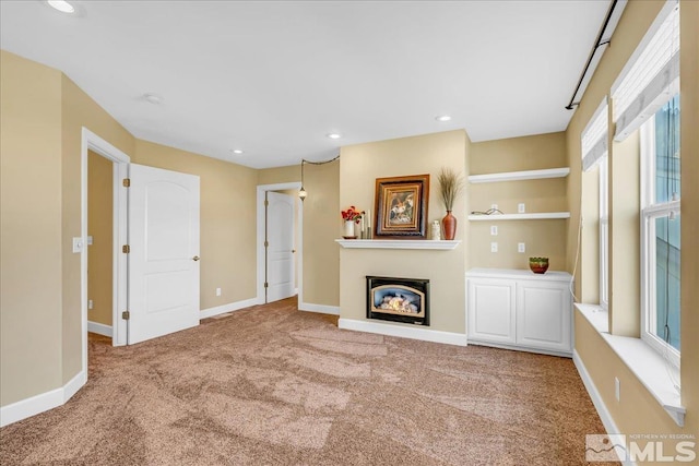 212 Foothill Meadows Ct, Genoa, NV 89411 - living area featuring carpet floors, a glass covered fireplace, baseboards, and recessed lighting