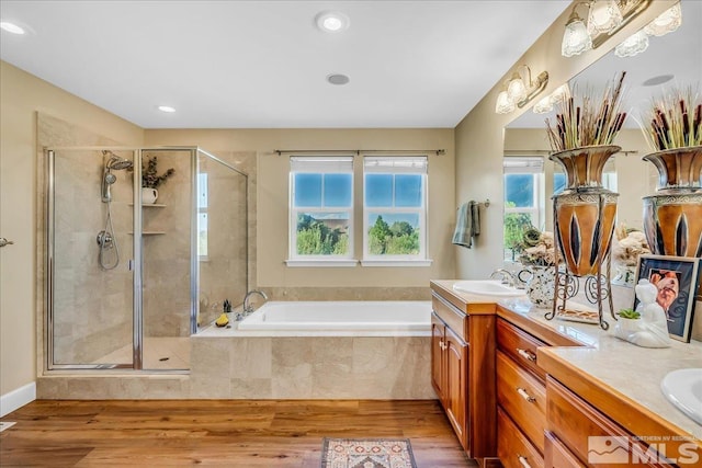 212 Foothill Meadows Ct, Genoa, NV 89411 - full bathroom featuring double vanity, a garden tub, a stall shower, plenty of natural light, and recessed lighting