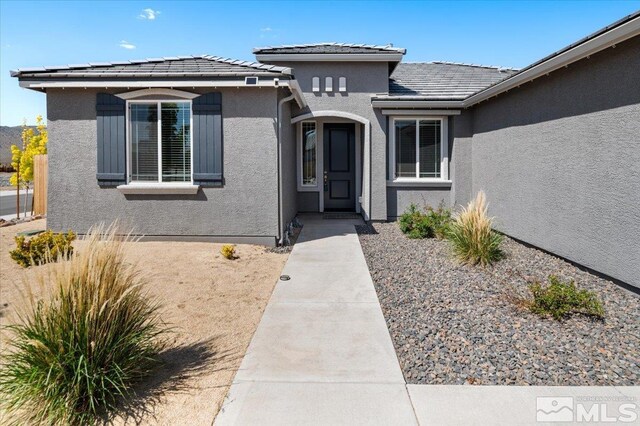 101 Cloud Berry Ct, Sparks, NV 89441 - entrance to property with stucco siding and a tile roof