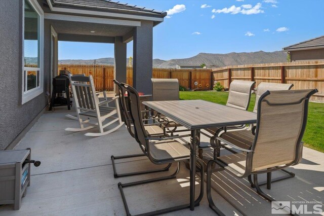 101 Cloud Berry Ct, Sparks, NV 89441 - view of patio / terrace featuring outdoor dining area, a mountain view, and a fenced backyard