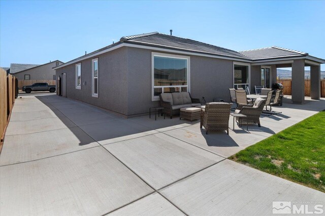 101 Cloud Berry Ct, Sparks, NV 89441 - rear view of property featuring fence, a patio area, outdoor lounge area, and stucco siding