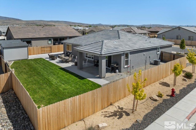 101 Cloud Berry Ct, Sparks, NV 89441 - back of property with stucco siding, a patio area, a residential view, an outdoor structure, and a storage shed