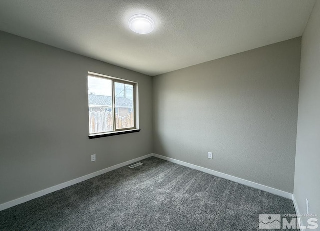 630 Wild Horse Way, Battle Mountain, NV 89820 - unfurnished room featuring dark carpet, baseboards, and a textured ceiling