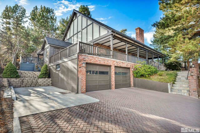 2820 Sagittarius Dr, Reno, NV 89509 - view of side of property featuring decorative driveway, stairs, and a chimney