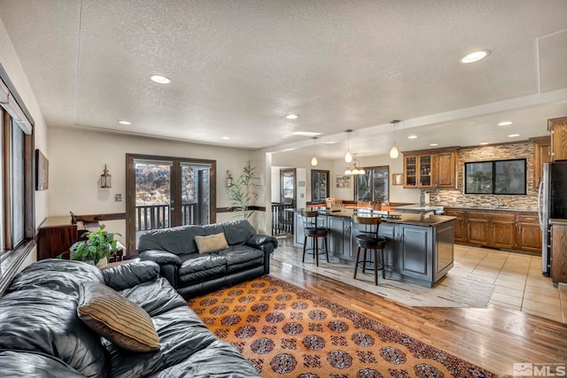 2820 Sagittarius Dr, Reno, NV 89509 - living area with a textured ceiling, recessed lighting, and light wood-style flooring
