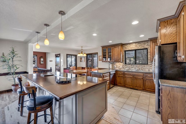 2820 Sagittarius Dr, Reno, NV 89509 - kitchen featuring dark countertops, brown cabinetry, stainless steel appliances, a sink, and recessed lighting