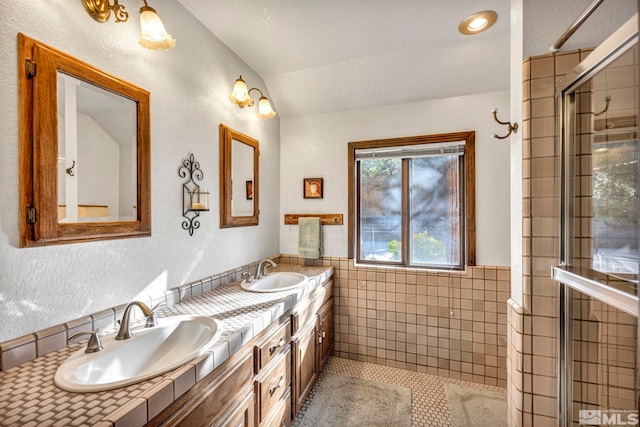 2820 Sagittarius Dr, Reno, NV 89509 - full bath with lofted ceiling, tile walls, tiled shower, double vanity, and tile patterned flooring