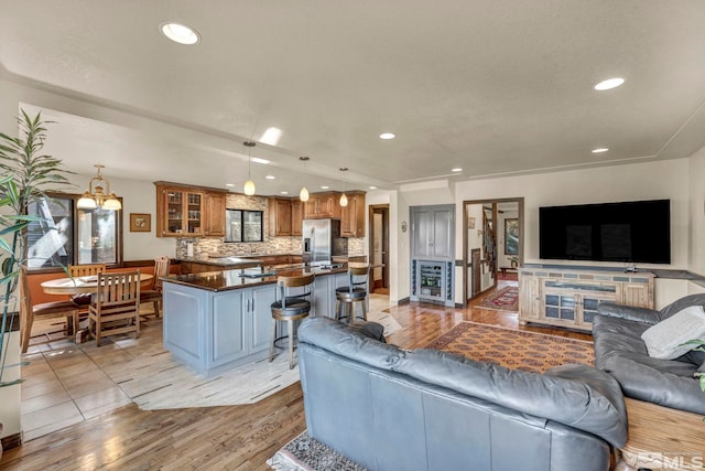 2820 Sagittarius Dr, Reno, NV 89509 - living room with beverage cooler, light wood-type flooring, recessed lighting, a chandelier, and baseboards