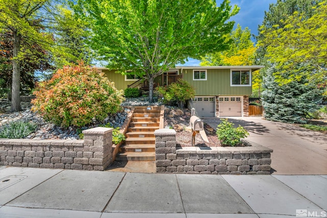 3295 Sunnyvale Ave, Reno, NV 89509 - view of front of home with stairway, concrete driveway, and a garage