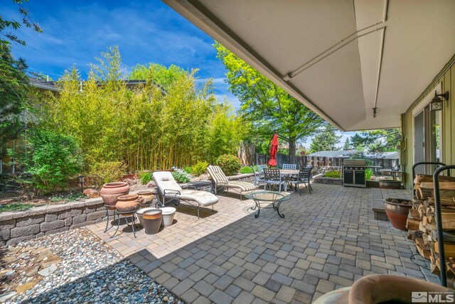 3295 Sunnyvale Ave, Reno, NV 89509 - view of patio with outdoor dining area and fence