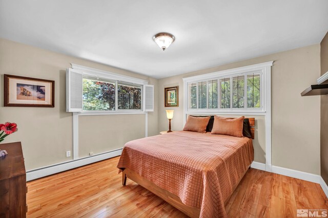 3295 Sunnyvale Ave, Reno, NV 89509 - bedroom with a baseboard heating unit, wood finished floors, and baseboards