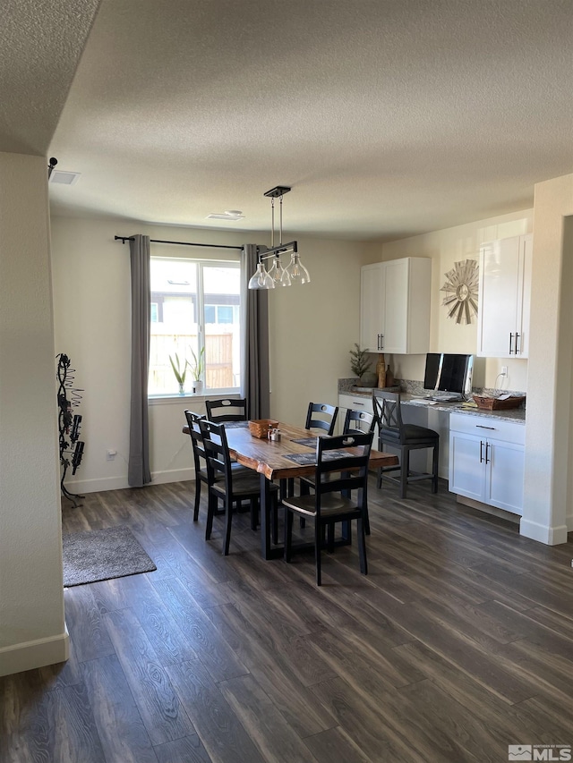 1848 Boundary Peak St, Carson City, NV 89701 - dining room featuring dark wood finished floors, a textured ceiling, and baseboards