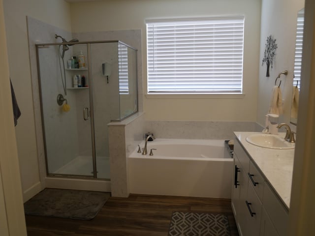 1848 Boundary Peak St, Carson City, NV 89701 - bathroom featuring wood finished floors, vanity, a shower stall, and a garden tub