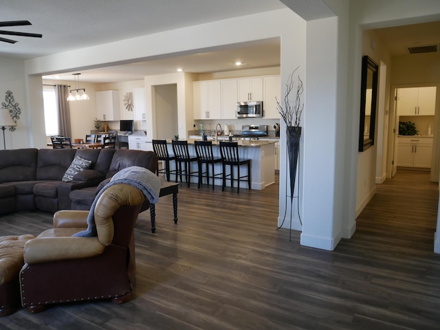 1848 Boundary Peak St, Carson City, NV 89701 - living room with dark wood-type flooring, ceiling fan, recessed lighting, a chandelier, and baseboards