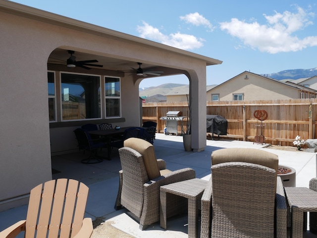 1848 Boundary Peak St, Carson City, NV 89701 - view of patio / terrace featuring ceiling fan, outdoor dining area, fence, a grill, and a mountain view