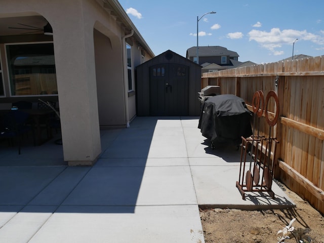 1848 Boundary Peak St, Carson City, NV 89701 - view of patio with a storage shed, fence, an outdoor structure, ceiling fan, and area for grilling