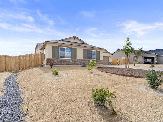 359 Bryce St, Dayton, NV 89403 - ranch-style home with stucco siding, fence, an attached garage, and stone siding