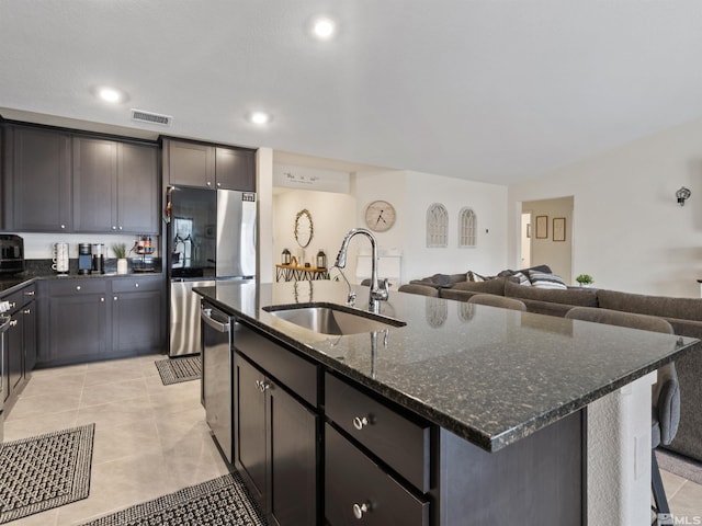359 Bryce St, Dayton, NV 89403 - kitchen with a sink, appliances with stainless steel finishes, dark stone counters, open floor plan, and an island with sink