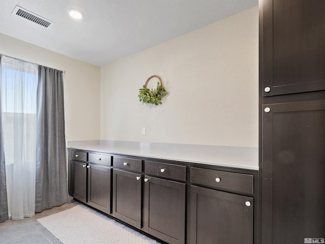 359 Bryce St, Dayton, NV 89403 - kitchen with dark brown cabinets, light countertops, and light tile patterned floors