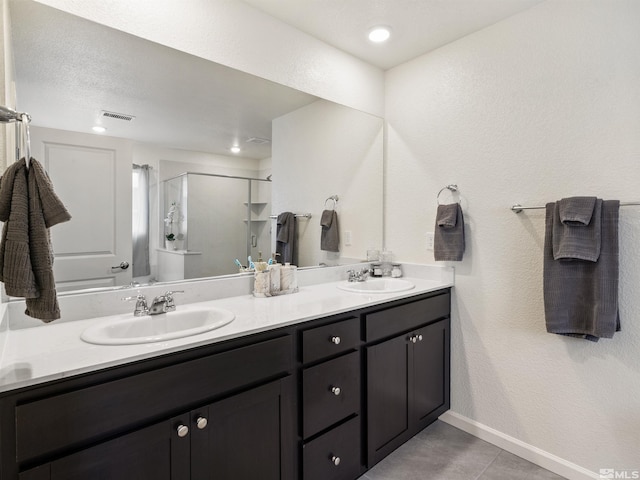 359 Bryce St, Dayton, NV 89403 - full bathroom with a shower stall, double vanity, baseboards, tile patterned flooring, and recessed lighting