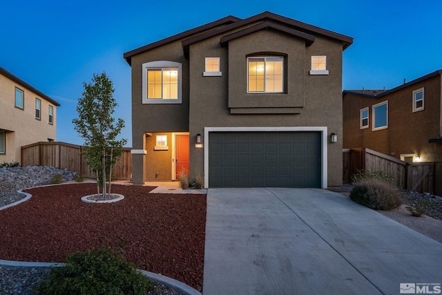 traditional-style house with stucco siding, driveway, a garage, and fence
