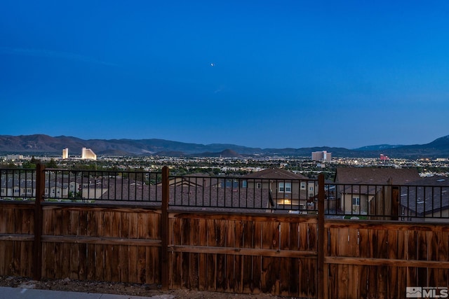 view of yard featuring a mountain view and fence